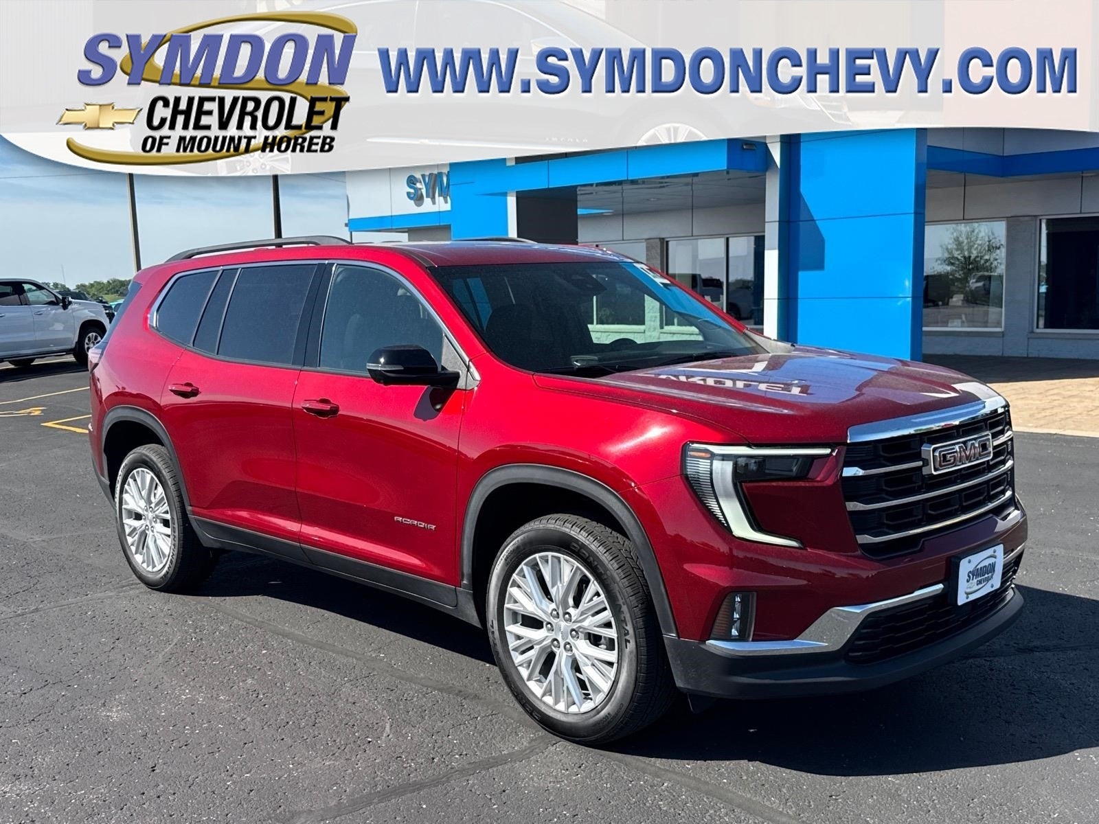 2026 GMC Acadia Elevation in Volcanic Red Tintcoat — front three-quarter view