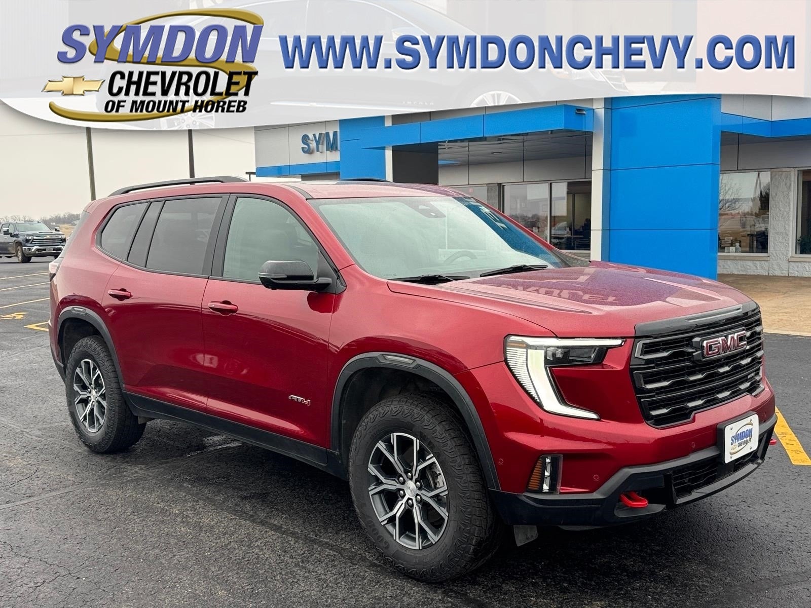 2025 GMC Acadia AT4 in Volcanic Red Tintcoat — front three-quarter view